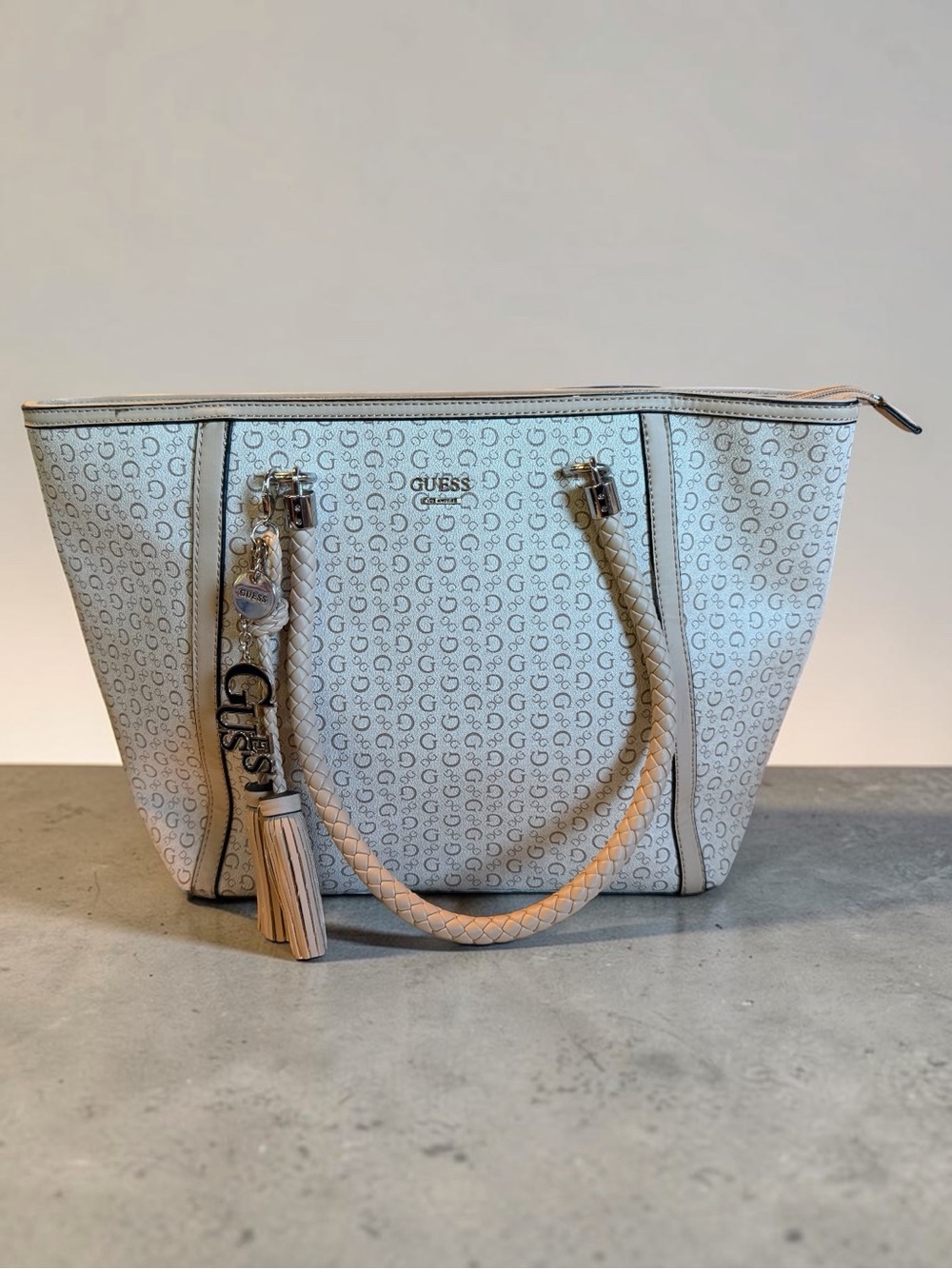 GUESS Cream Monogram Tote with Braided Handles and Tassel